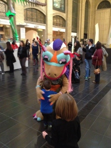 Aiden hugging the dinosaur mascot