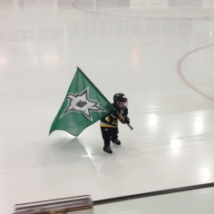 Carrying his team's flag onto the ice