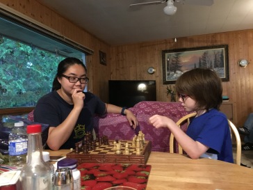 Aiden playing chess with Shauna's girlfriend.